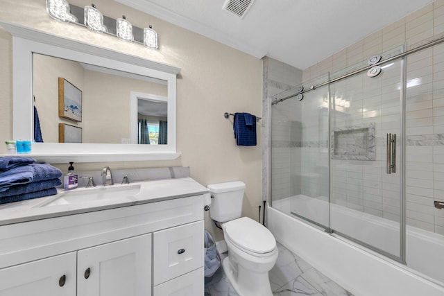 full bathroom with shower / bath combination with glass door, vanity, and toilet