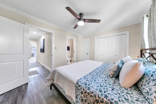 bedroom featuring crown molding, dark wood-type flooring, ceiling fan, and ensuite bathroom