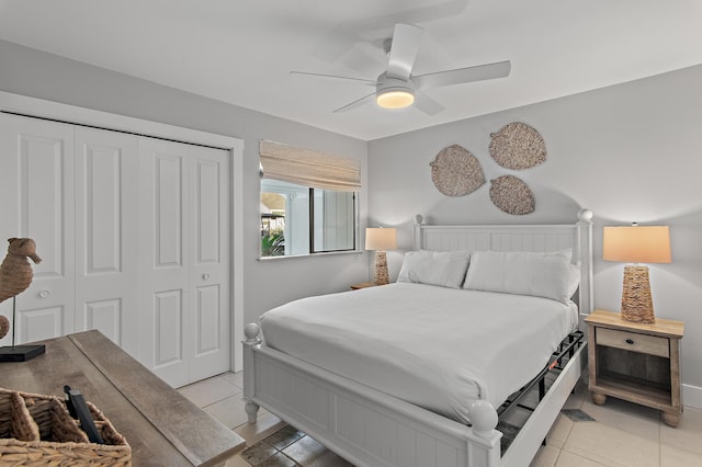 bedroom with light tile patterned floors, ceiling fan, and a closet