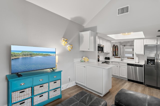 kitchen featuring white cabinetry, appliances with stainless steel finishes, and backsplash