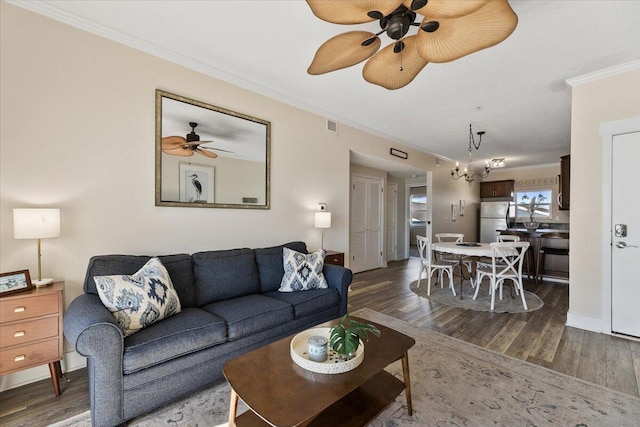 living room with dark hardwood / wood-style flooring and crown molding