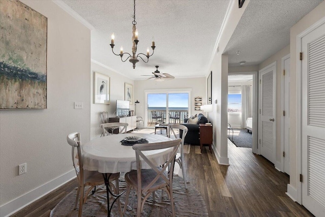 dining space featuring a textured ceiling, ceiling fan with notable chandelier, and dark hardwood / wood-style floors