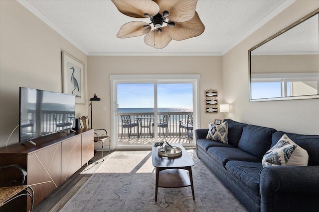 living room featuring a wealth of natural light, crown molding, ceiling fan, and hardwood / wood-style flooring