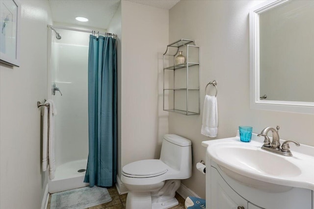 bathroom featuring tile patterned floors, curtained shower, vanity, and toilet