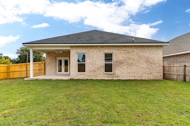 back of property featuring a lawn, a patio area, and french doors