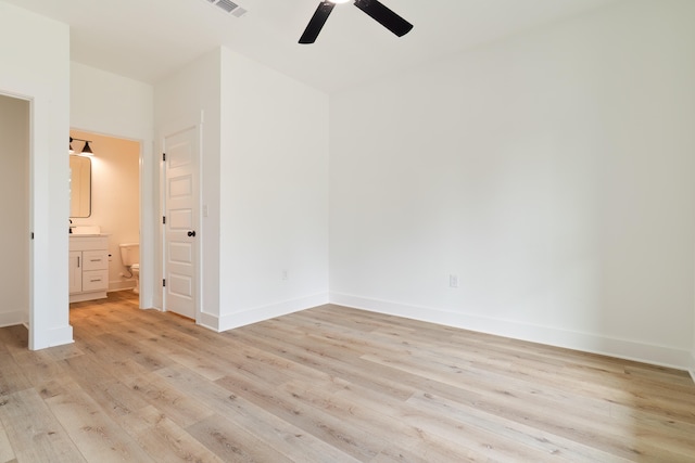 unfurnished bedroom with light wood-type flooring, connected bathroom, and ceiling fan