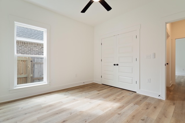 unfurnished bedroom with ceiling fan, light hardwood / wood-style floors, and a closet