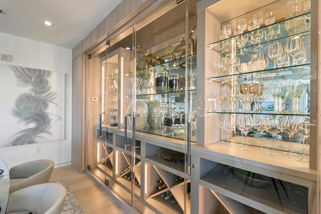 wine area featuring hardwood / wood-style floors and indoor bar