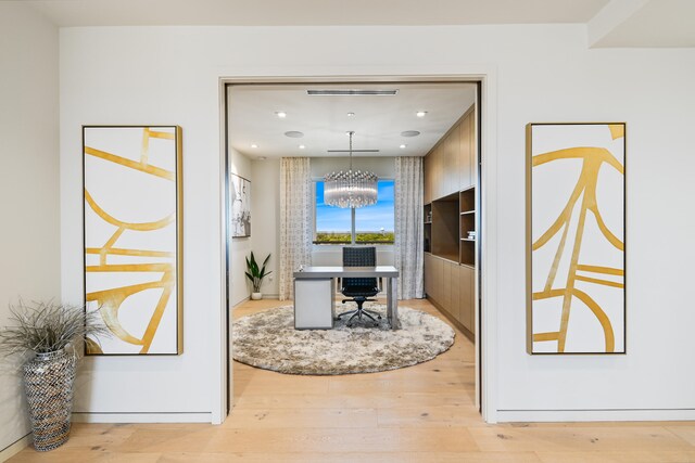 interior space featuring light hardwood / wood-style floors and a chandelier