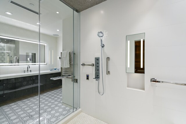 bathroom with vanity, tile patterned flooring, and an enclosed shower