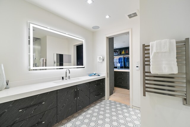 bathroom featuring radiator heating unit and vanity