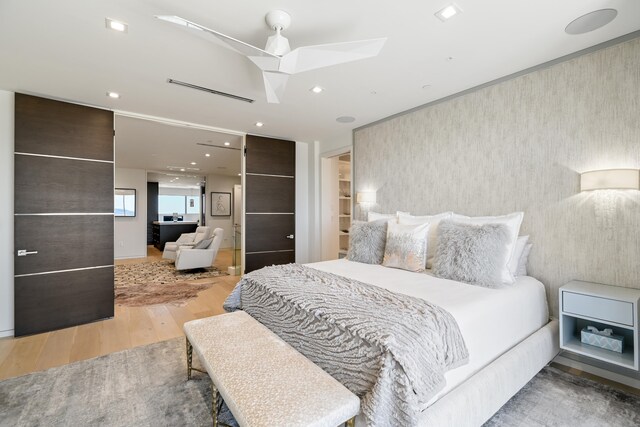 bedroom with ceiling fan and light hardwood / wood-style flooring