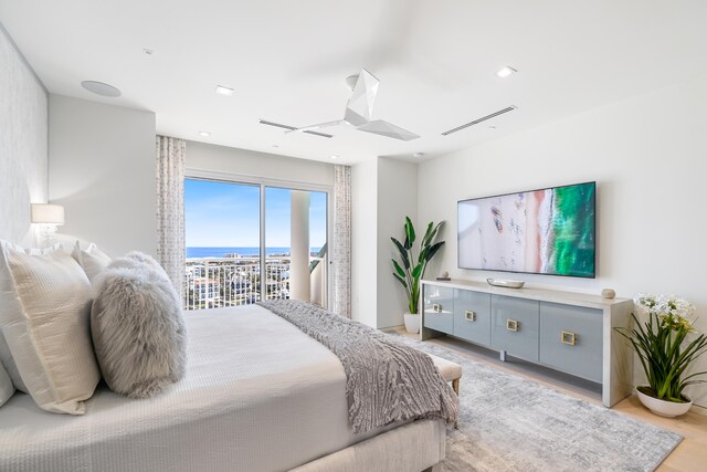 bedroom with light wood-type flooring and access to exterior