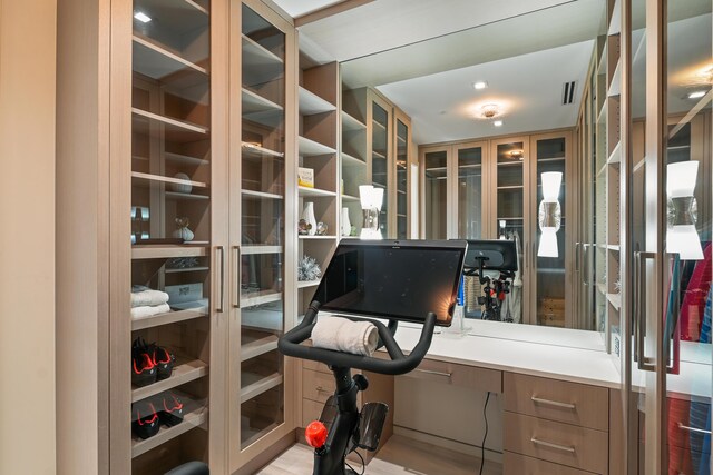 office space featuring light hardwood / wood-style flooring and built in desk