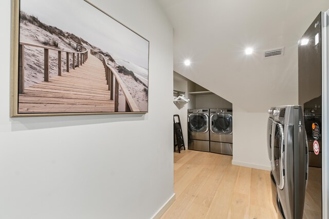 washroom featuring light wood-type flooring and independent washer and dryer