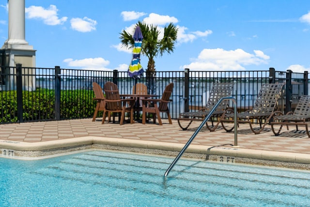 view of swimming pool featuring a patio area