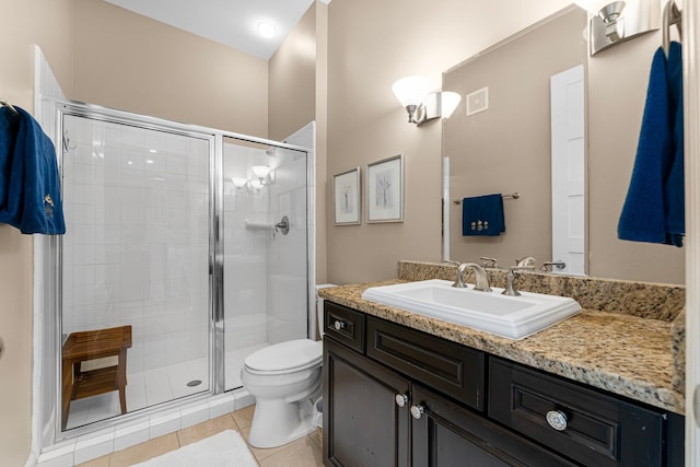 bathroom featuring vanity, a shower with shower door, toilet, and tile patterned flooring