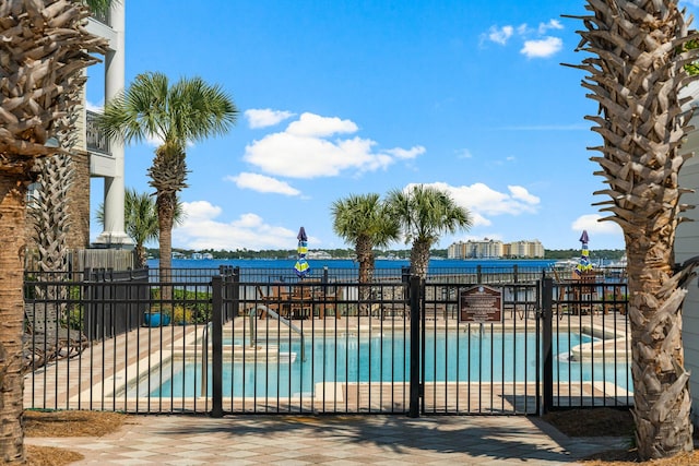 view of swimming pool with a water view