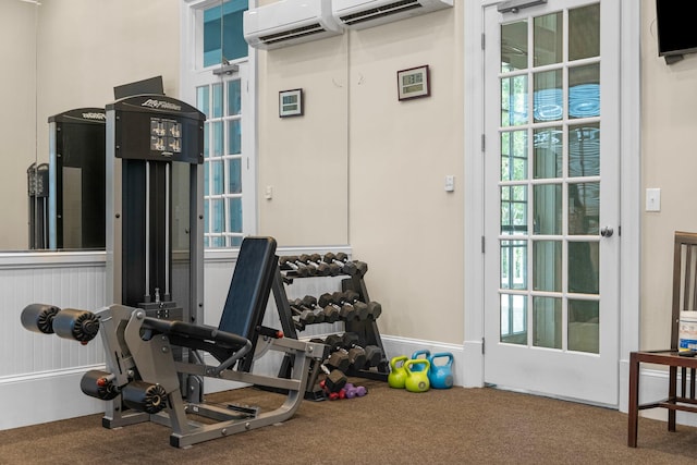 workout area featuring carpet flooring and a wall mounted air conditioner