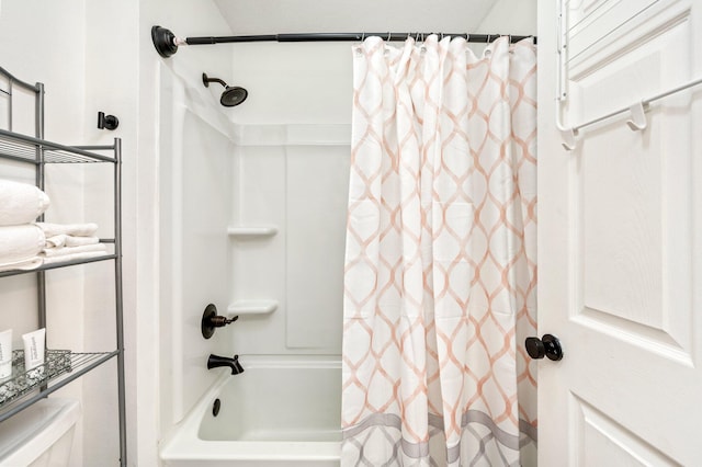 bathroom featuring toilet and shower / bath combo