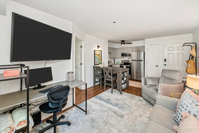 office space featuring light wood-type flooring, sink, and ceiling fan