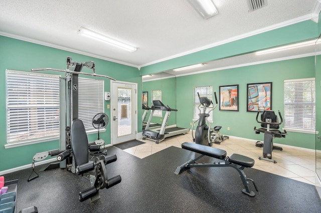 workout area featuring a textured ceiling, ornamental molding, and a wealth of natural light