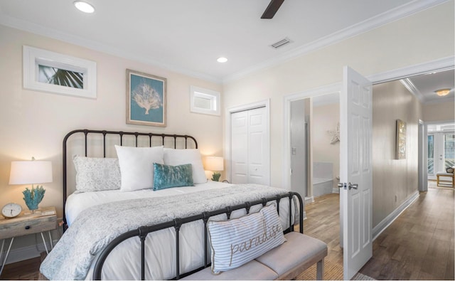 bedroom featuring ceiling fan, a closet, ornamental molding, and wood-type flooring