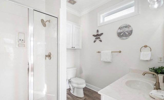 bathroom featuring an enclosed shower, hardwood / wood-style floors, ornamental molding, vanity, and toilet