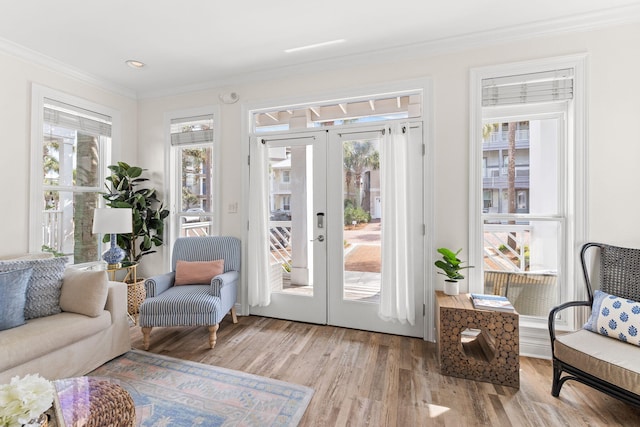 interior space with french doors, crown molding, and light hardwood / wood-style floors