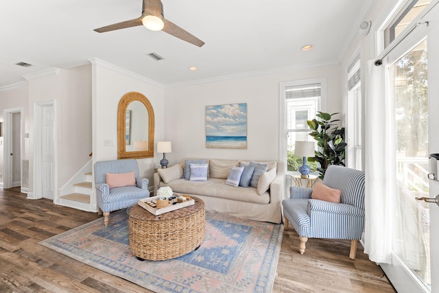 living room with ornamental molding, ceiling fan, and hardwood / wood-style flooring