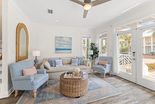 living room with a healthy amount of sunlight, wood-type flooring, and french doors