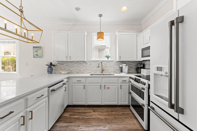 kitchen featuring kitchen peninsula, white cabinetry, premium appliances, and sink