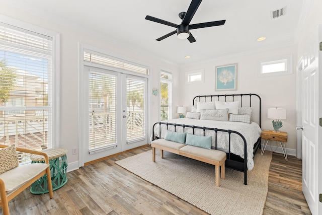 bedroom with wood-type flooring and multiple windows