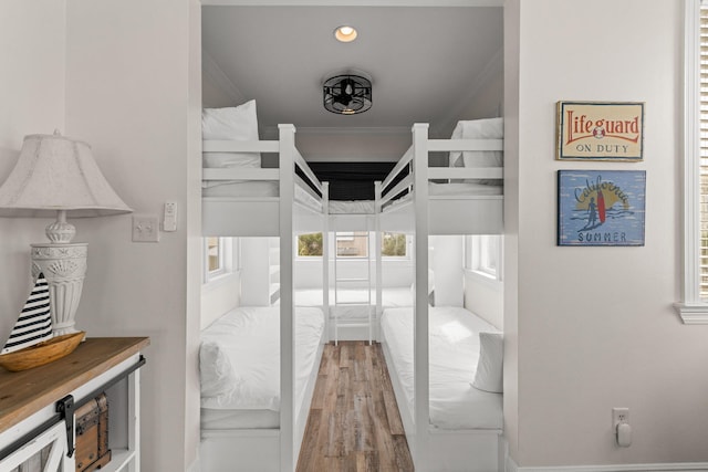 bedroom with crown molding and hardwood / wood-style flooring