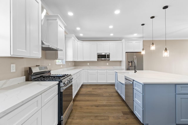 kitchen featuring white cabinetry, stainless steel appliances, light stone countertops, and pendant lighting