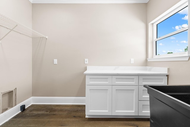 laundry area featuring dark wood-type flooring