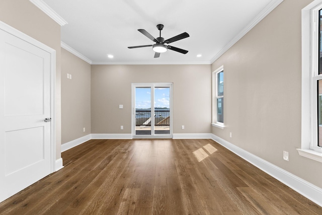 unfurnished room featuring dark wood-type flooring, ceiling fan, and ornamental molding