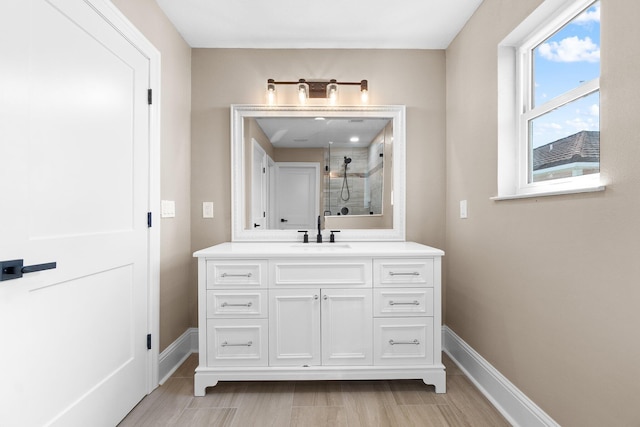 bathroom with vanity and a tile shower