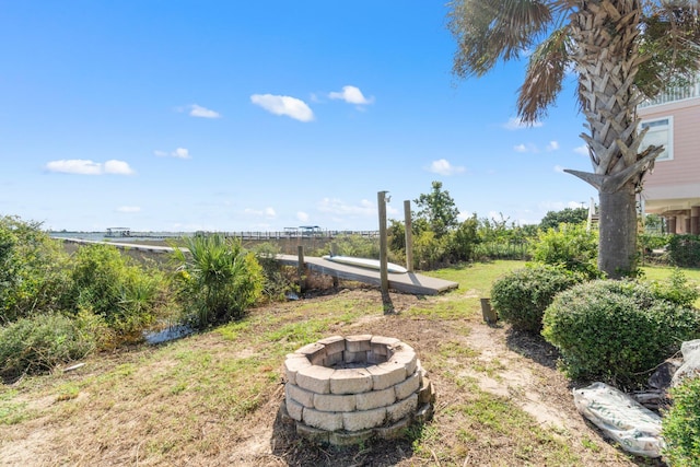 view of yard featuring an outdoor fire pit