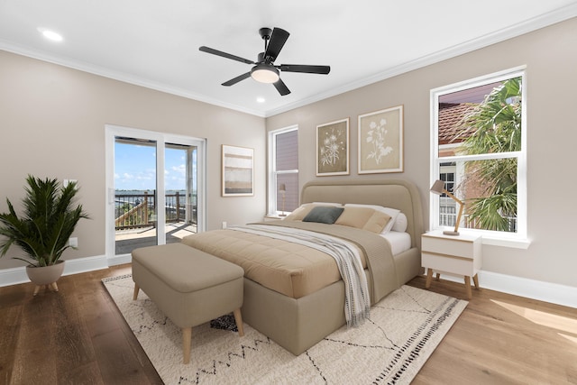 bedroom featuring ornamental molding, baseboards, access to outside, and wood finished floors