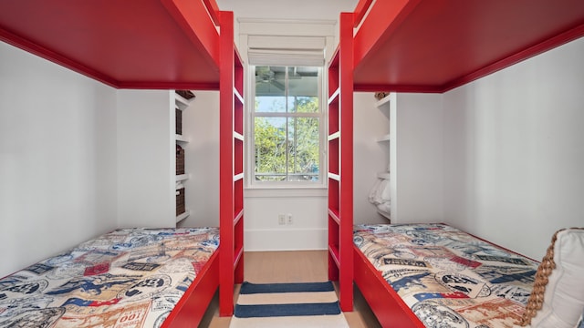 bedroom with crown molding and wood-type flooring