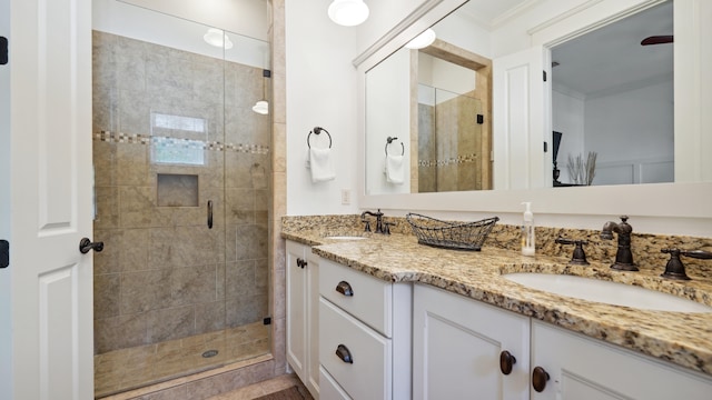 bathroom featuring vanity, crown molding, and an enclosed shower