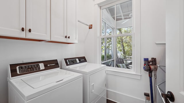 washroom with independent washer and dryer and cabinets