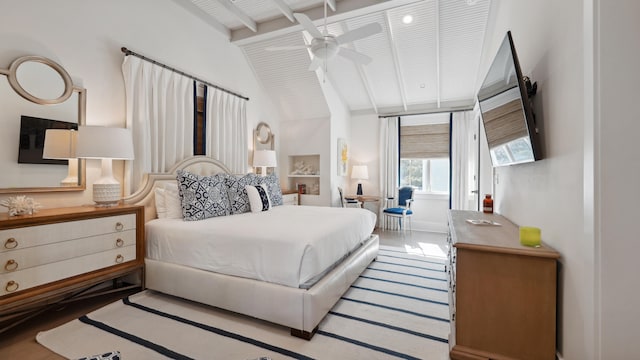 bedroom with lofted ceiling with beams and hardwood / wood-style floors