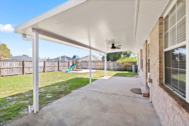 view of patio / terrace featuring a playground and ceiling fan