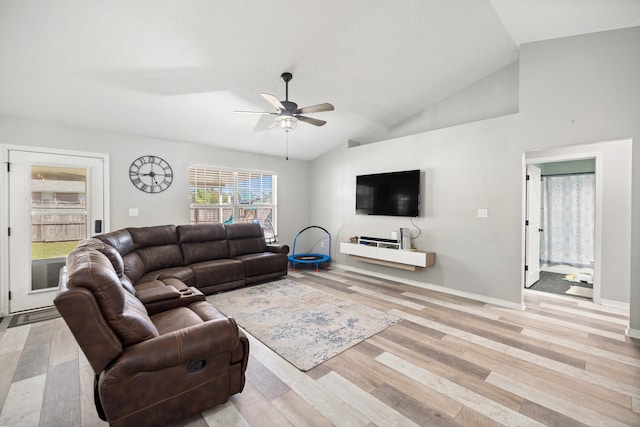 living room featuring light hardwood / wood-style floors, ceiling fan, and lofted ceiling