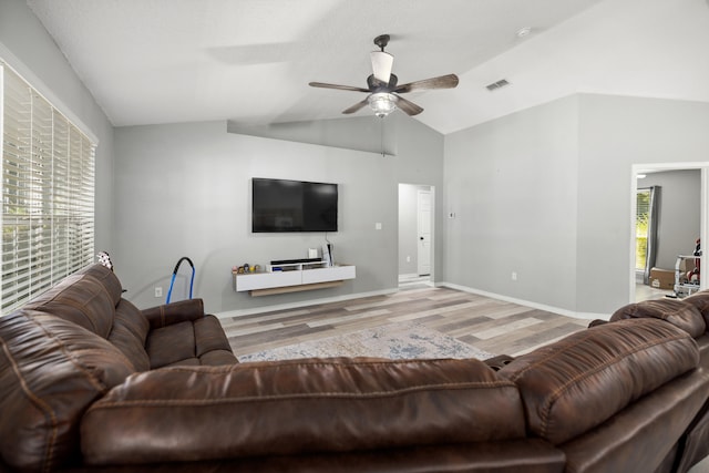 living room featuring light hardwood / wood-style flooring, ceiling fan, and lofted ceiling