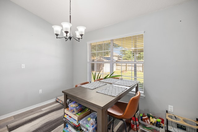 dining area featuring an inviting chandelier