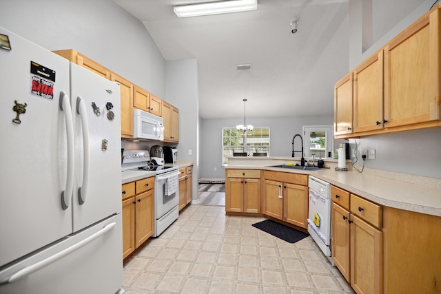 kitchen with kitchen peninsula, white appliances, sink, an inviting chandelier, and hanging light fixtures