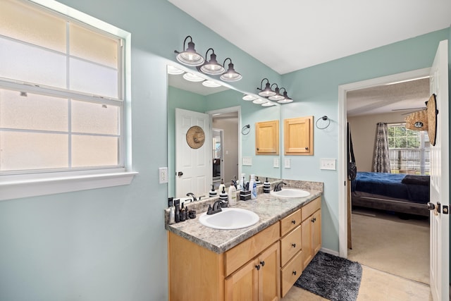 bathroom featuring tile patterned flooring and vanity